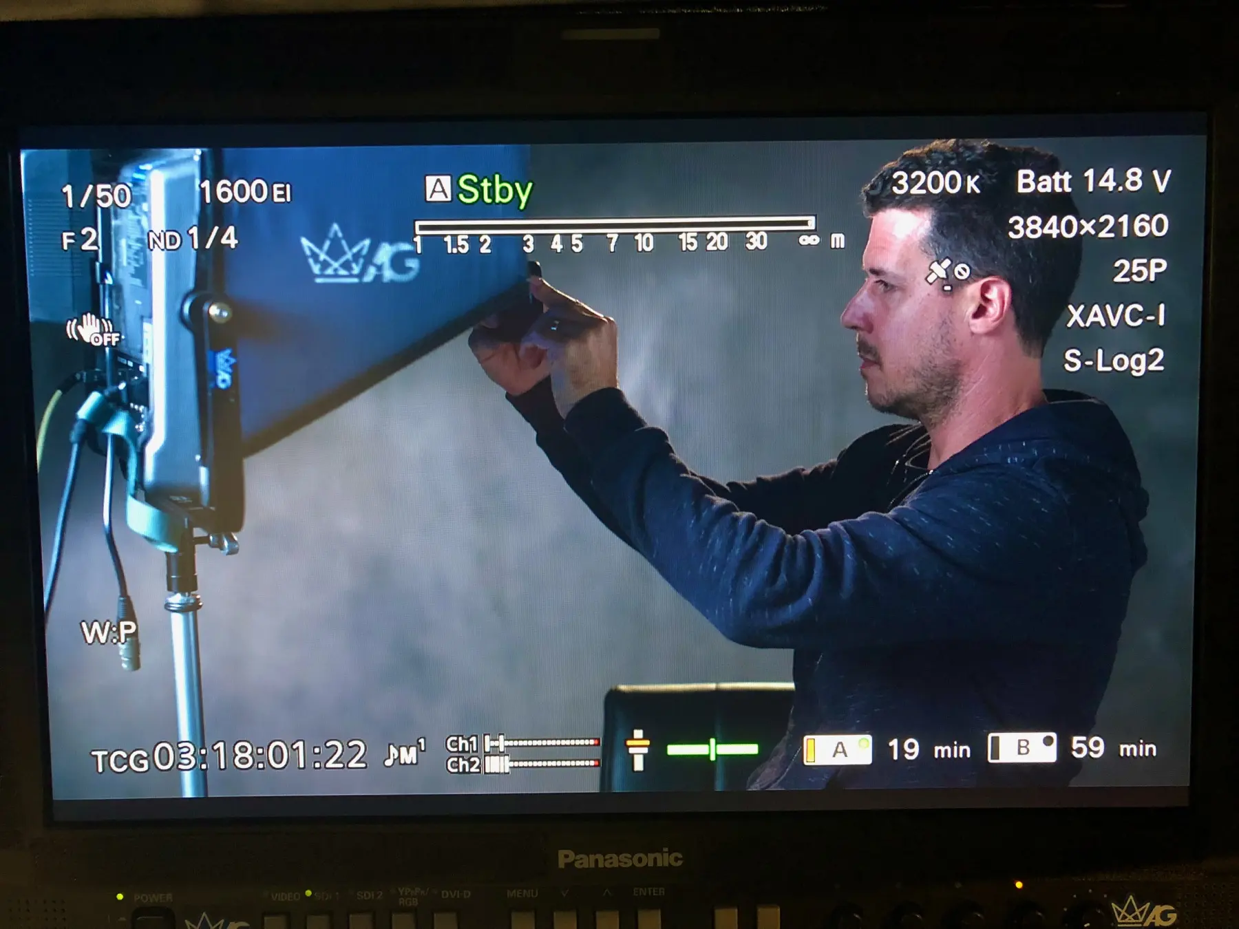 Itai Raziel framing a shot on set, seen on the camera monitor